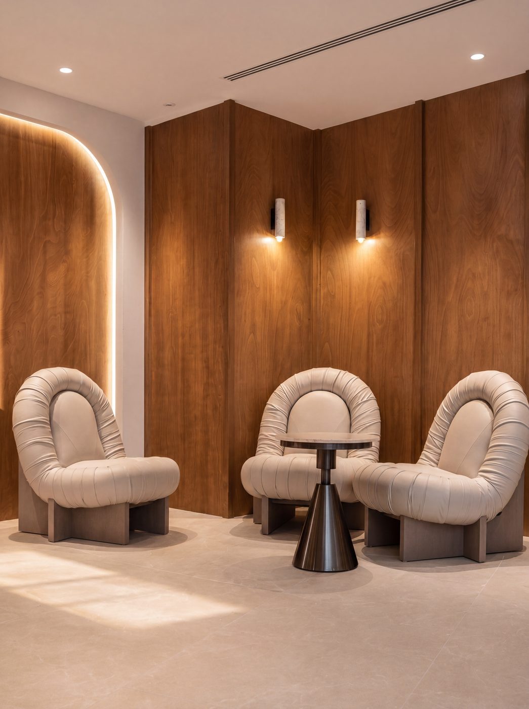 HiveOne business lounge with cream leather armchairs against walnut panelling
